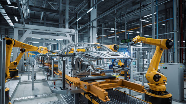 istock Car Factory 3D Concept: Automated Robot Arm Assembly Line Manufacturing Advanced High-Tech Green Energy Electric Vehicles. Construction, Building, Welding Industrial Production Conveyor. Close-up 1352825127
