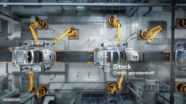 Aerial Car Factory 3d Concept Automated Robot Arm Assembly Line Manufacturing Advanced Hightech Green Energy Electric Vehicles Construction Building Welding Industrial Production Conveyor Stock Photo - Download Image Now