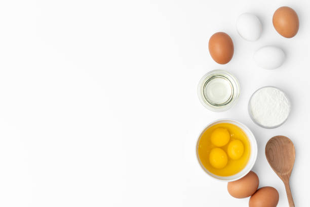 istock Metal whisk and eggs for cooking isolated on white 1352825648