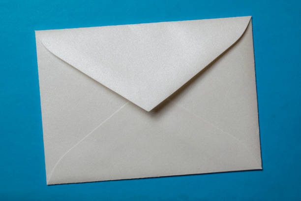 istock white envelope blank note pinned to a blue notice board 1352825649