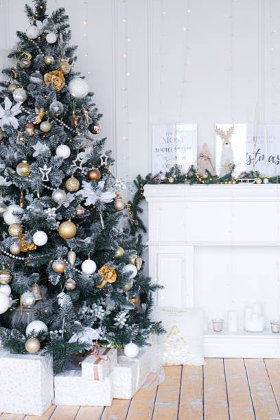 istock Christmas tree with presents underneath in living room 1352828149