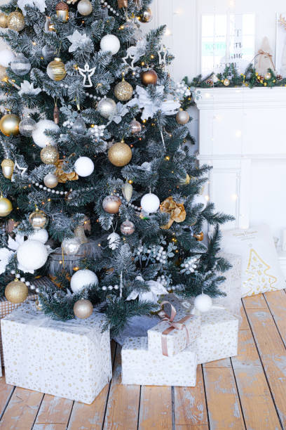 istock Christmas tree with presents underneath in living room 1352828201