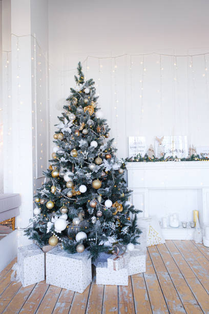 istock Christmas tree with presents underneath in living room 1352828203