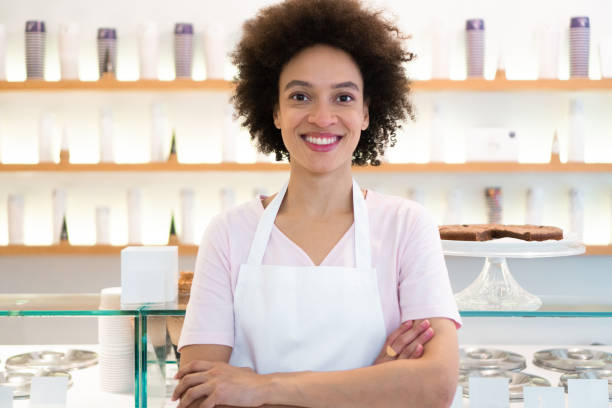 istock Happy woman working at an ice cream parlor 1352828380