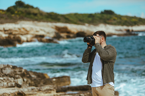 professional photographer shooting seascape. copy space