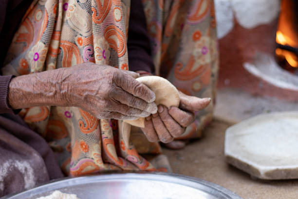 istock Senior woman hand making chapati. 1352830620