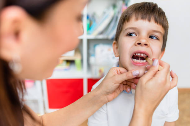 istock A little preschool boy is engaged in a speech therapist office and corrects his speech 1352831819