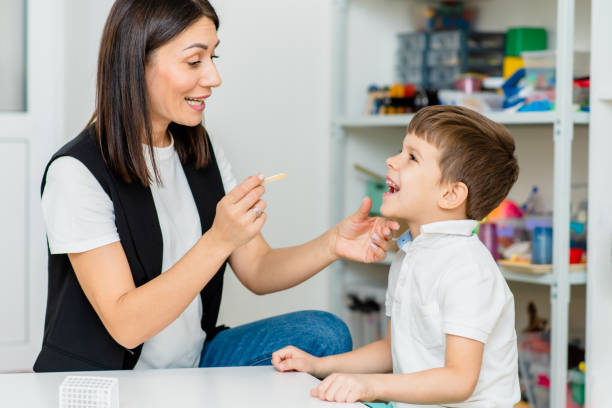 istock A little preschool boy is engaged in a speech therapist office and corrects his speech 1352831868