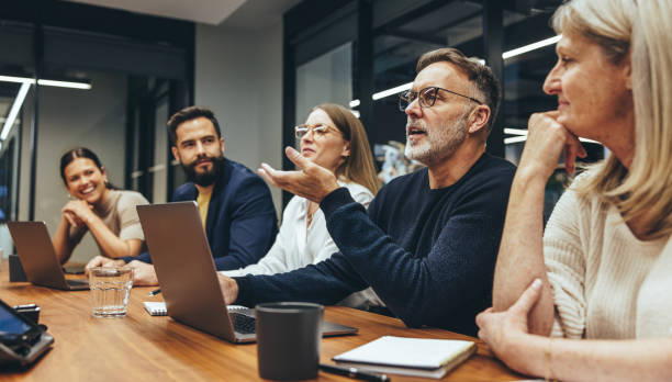 Mature manager leading a discussion in a boardroom