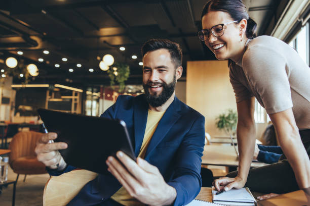istock Two businesspeople taking a video call in a co-working space 1352833653
