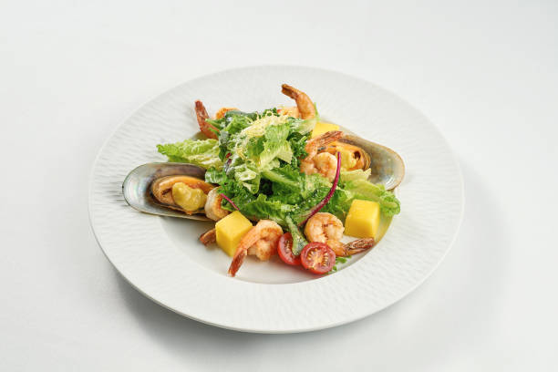 istock Shrimp and mussel salad, mango in a white plate on a tablecloth 1352833842