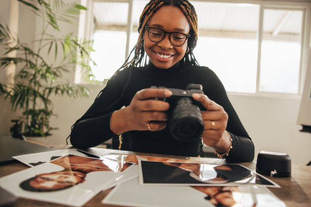 istock Happy young photographer holding a dslr camera 1352836234