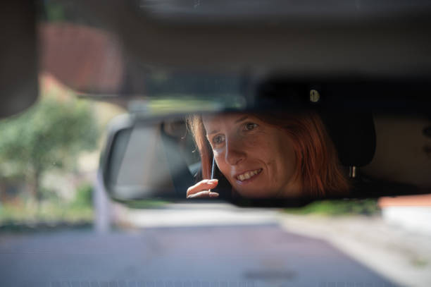 istock Woman talking on mobile phone while driving 1352837908