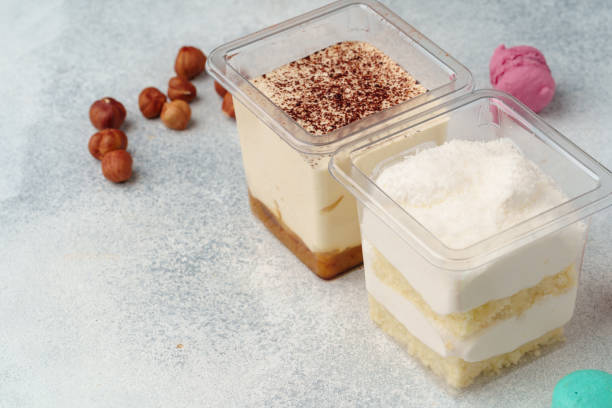 istock Creamy dessert in a plastic box on gray table 1352838112