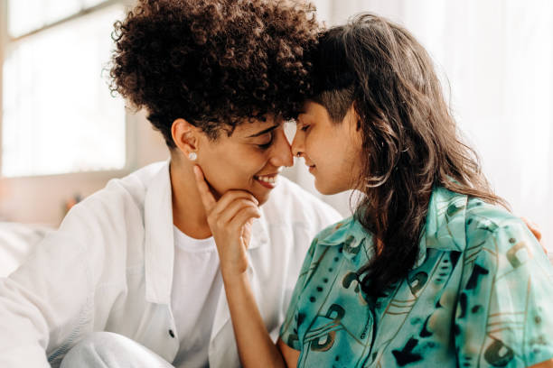 istock Romantic lesbian couple touching their noses 1352838176