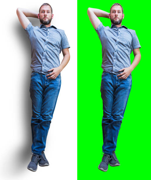Young caucasian man in casual clothes lying on green screen and white background with shadow. Top view stock photo