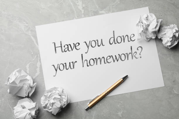 istock Paper sheet with phrase HAVE YOU DONE YOUR HOMEWORK? on grey marble table, flat lay 1352840746