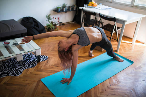 istock Woman practicing yoga and doing chakrasana pose 1352841461