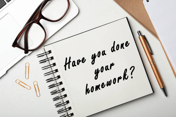 istock Stylish notebook with phrase HAVE YOU DONE YOUR HOMEWORK? on table, flat lay 1352841501