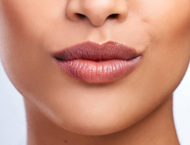 istock Cropped shot of an unrecognizable woman's beautiful full lips 1352843088