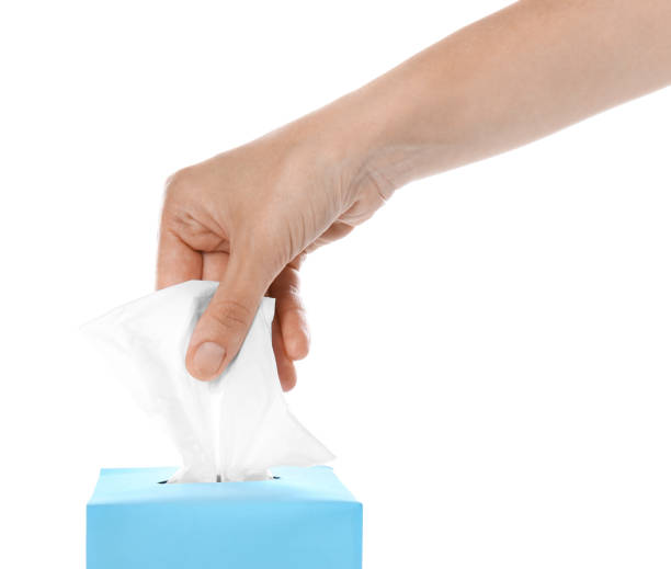 istock Woman taking paper tissue from box on white background, closeup 1352843307