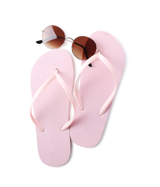 istock Flip flops and sunglasses on white background, top view. Beach objects 1352843326