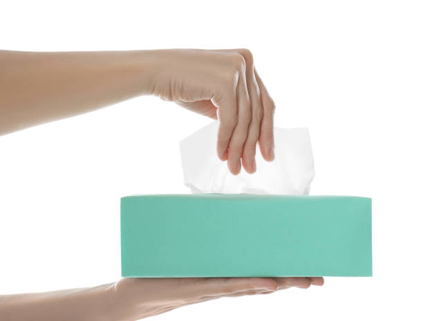 istock Woman taking paper tissue from box on white background, closeup 1352843328