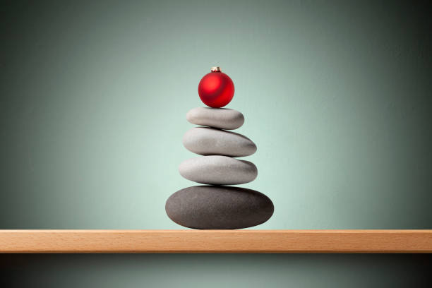 istock Balanced pebbles christmas tree with red Christmas ball on shelf 1352844127