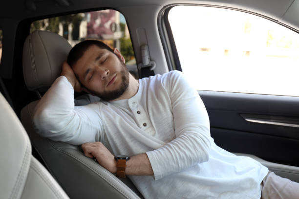 istock Tired man sleeping in his modern car 1352847038