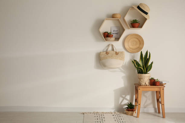 istock Room interior with hexagon wooden shelves on light wall. Space for text 1352847180