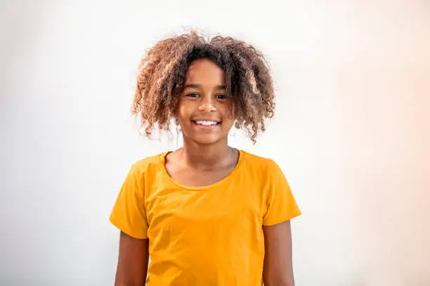 Photo of Portrait of smiling black teenage girl posing at home