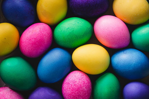 Easter eggs in a basket decorated with grass on a table