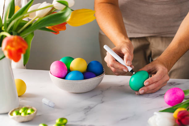istock Close-up of a woman decorating easter eggs 1352848550