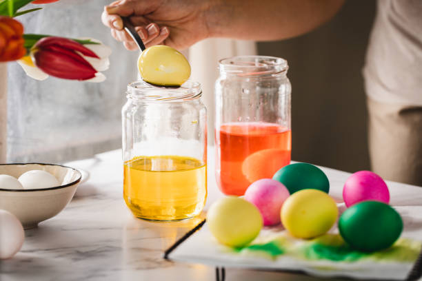 istock Woman coloring easter eggs with natural dye at home 1352848601