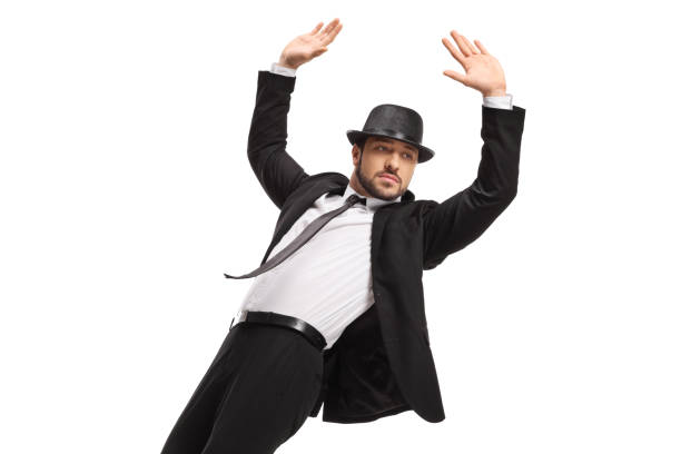 istock Man in a suit and top hat raising arms 1352849923