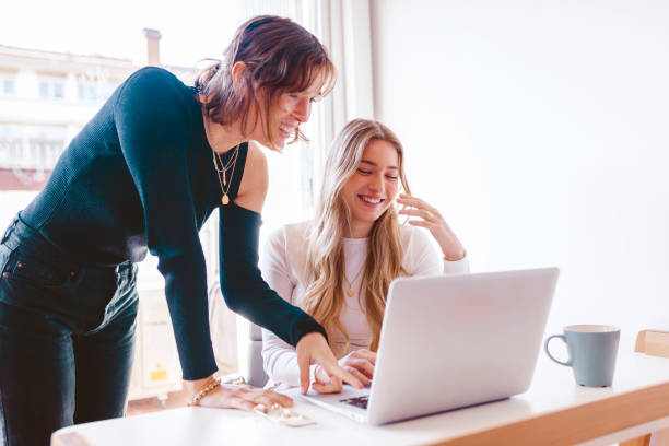istock Two young women working together with laptop at the office 1352850934