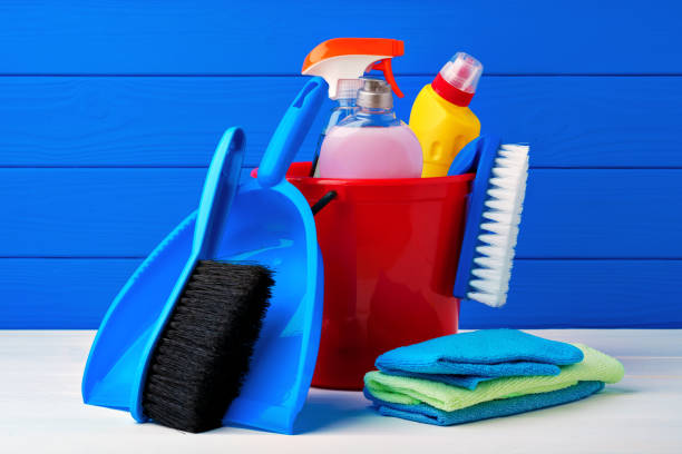 istock Various cleaning items against blue wooden background 1352851139