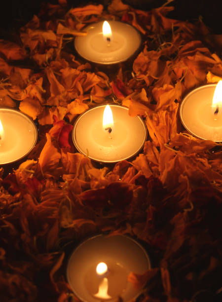 istock Tea light candles and marigold flower petals 1352851869
