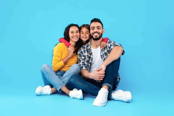 istock Loving Arab Family Hugging Sitting In Studio Over Blue Background 1352852646