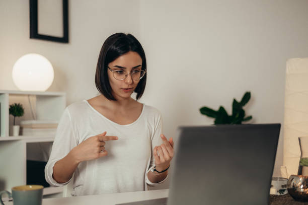 istock Woman using a laptop for an online meeting while working from home 1352853663