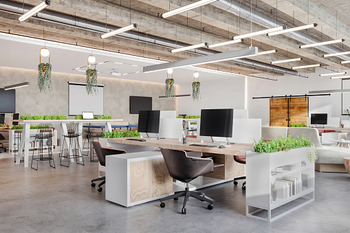 Modern open plan office space interior. Desks, computers, armchairs, shelf, plant, concrete ceiling, LED lights. Template for copy space. Render.