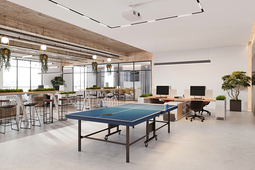 Modern open plan office space interior. Tennis table, desks, chairs, computers, projector, concrete ceiling, and LED lights. Template for copy space. Render.