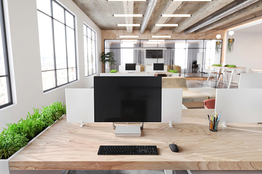 Large blank monitor with keyboard and mouse on office desk. Corporate business interior. Template for copy space. Render.