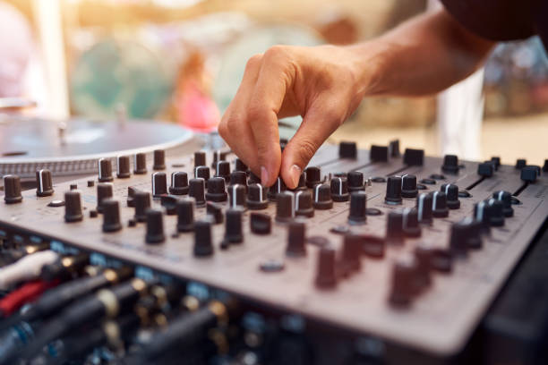 Close up of a DJ playing music on the outdoor party. stock photo