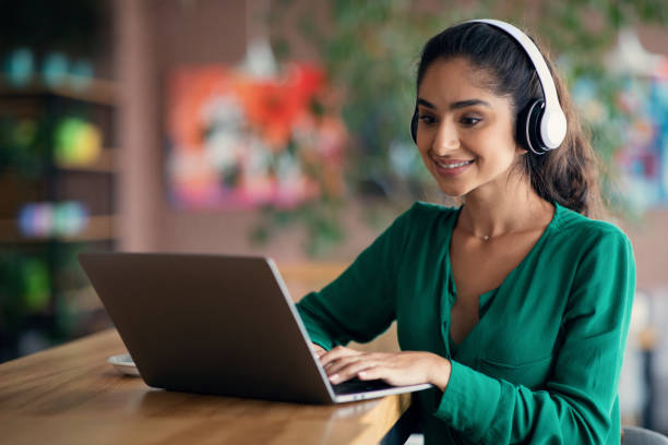 istock Pretty indian woman attending webinar, cafe interior, copy space 1352855097