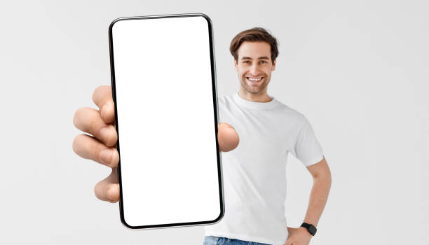istock Mockup Image Of Young Handsome Man Holding Smartphone With Big Blank Screen 1352856776