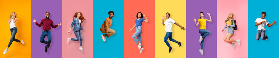 Full length of cheerful positive energy diverse millennial men, women jumping from success, emotions of victory, isolated on colorful background, panorama, free space. Freedom, movement, fun and joy