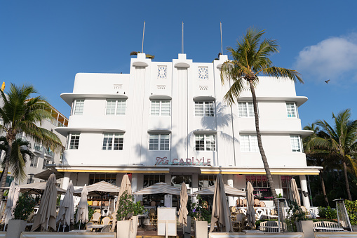 Miami, USA - April 15, 2021: sidewalk cafe at The Carlyle hotel on Ocean Drive in Florida.