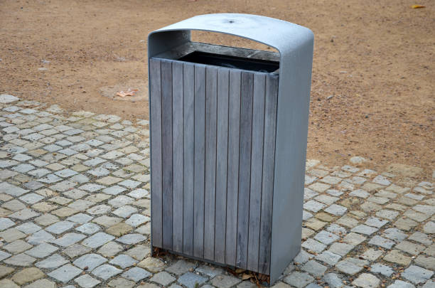 istock red chairs and round tables and benches on a cobbled square with a sand surface of compacted gravel. ice icing. steel dark gray water drinker for visitors and tourists. waste bin lined with wood 1352860069