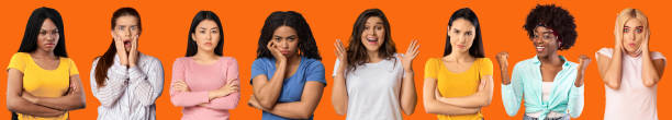 istock Range of multiple diverse people faces in collage over orange studio background 1352860515